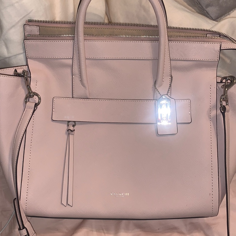 Coach light pink handbag can be used as a cross body as well